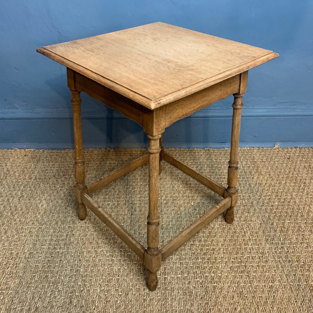 An Edwardian oak square table circa 1910 by Waring and Gillow