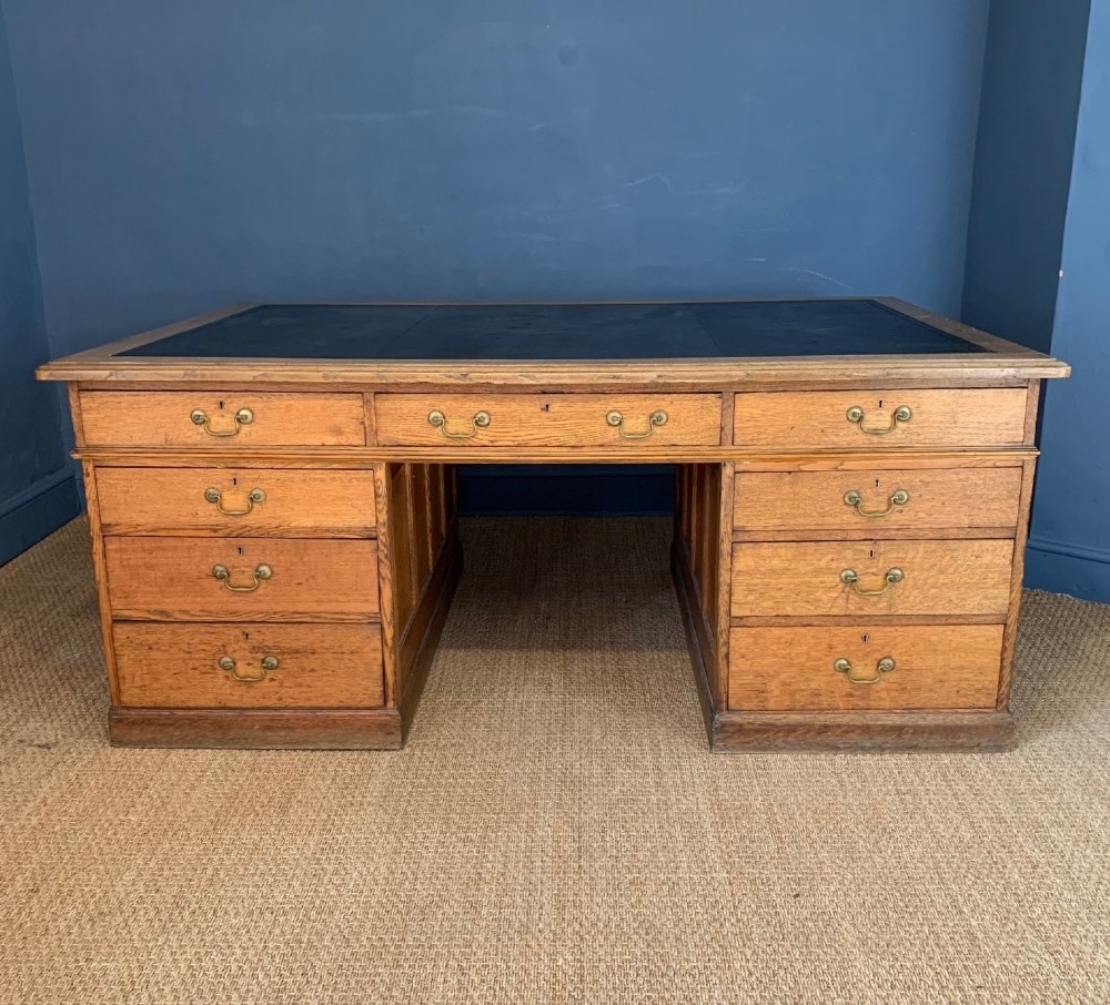 A large late Victorian oak partners desk circa 1890