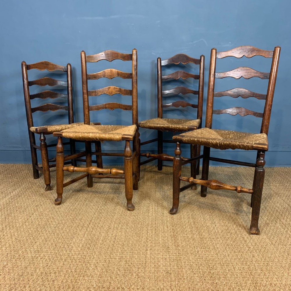 A harlequin set of four late 18th century Cheshire ladderback chairs