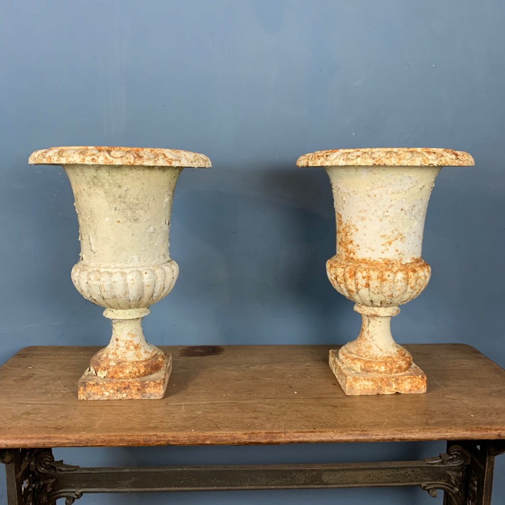 A pair of mid 19th century cast iron garden urns 