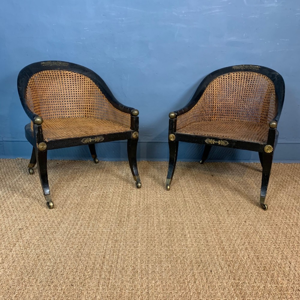 A rare pair of Regency ebonised and cane low bergere chairs circa 1815 