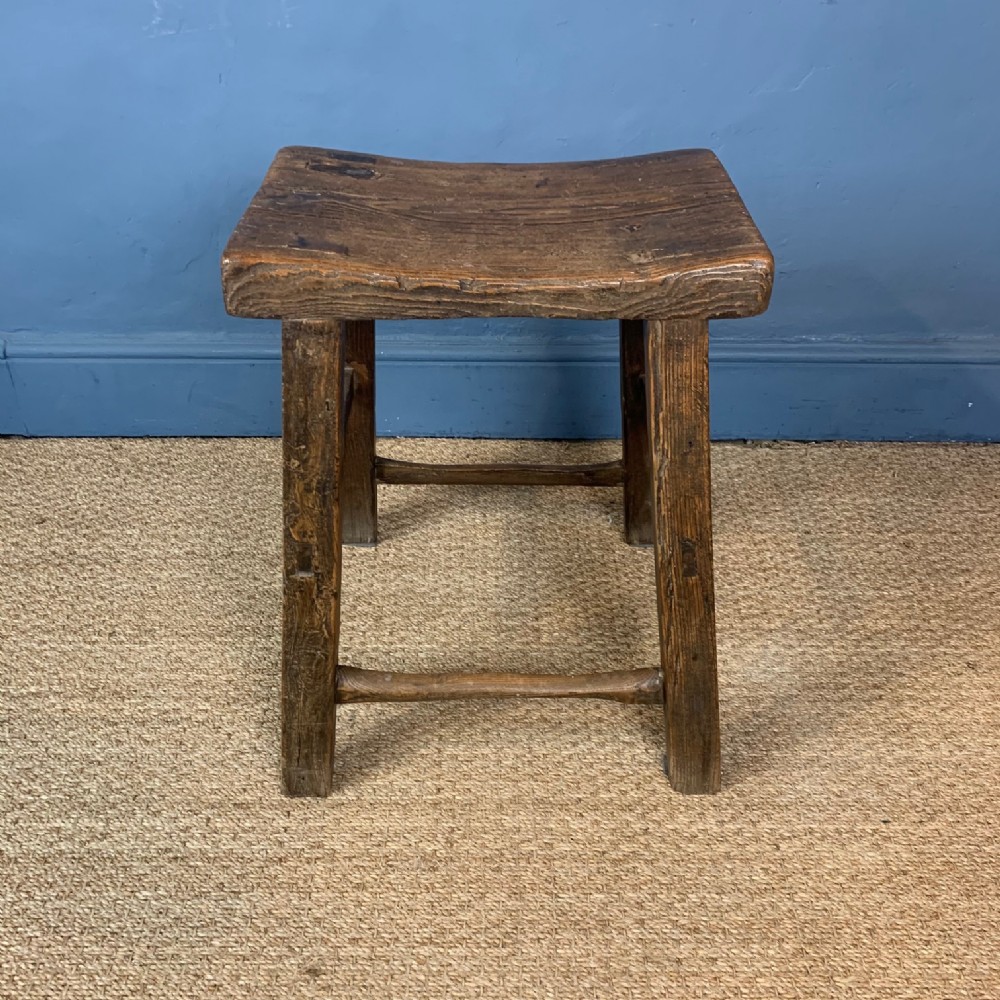 A 19th century Elm Stool with saddle top