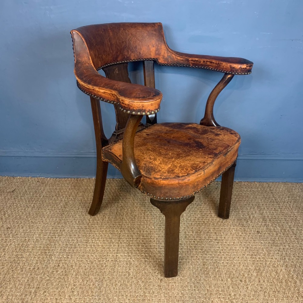 A late Victorian mahogany and leather desk chair c 1890