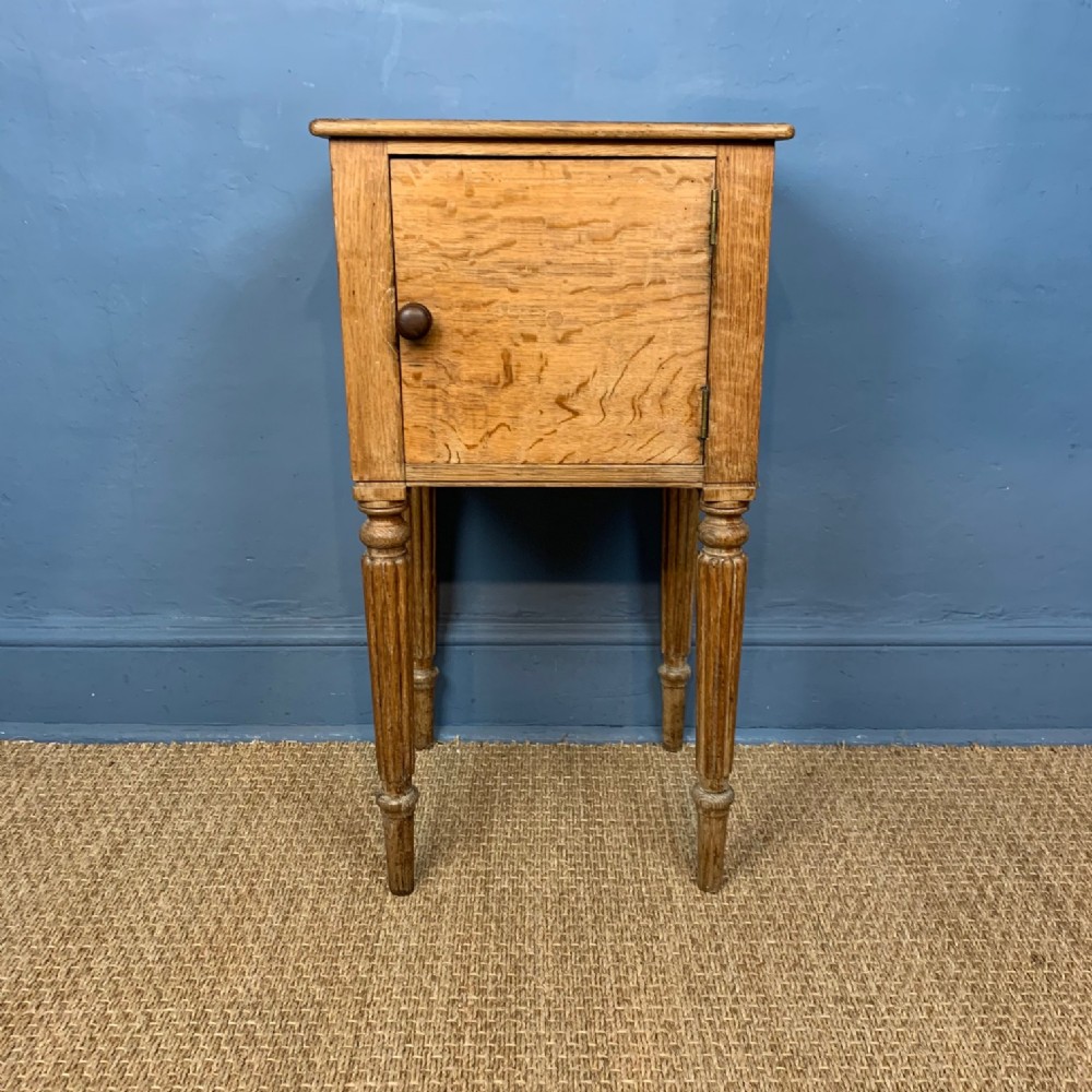 A George IV pale oak bedside table circa 1820