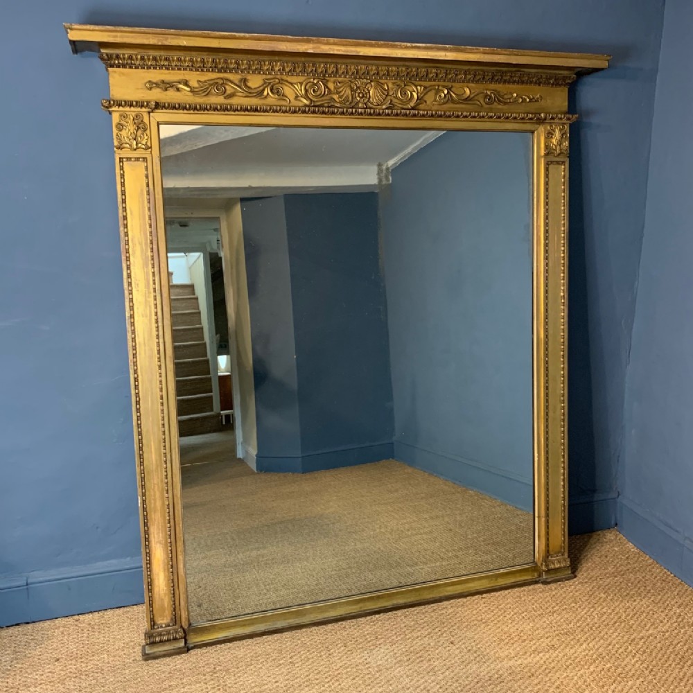 A George IV gilt over mantel mirror c 1820 of imposing proportions