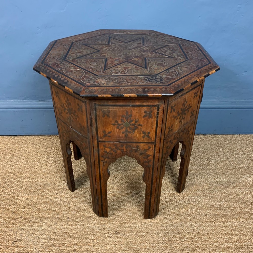 A Hoshiarpur brass and ebony inlaid shisham wood octagonal table c 1890