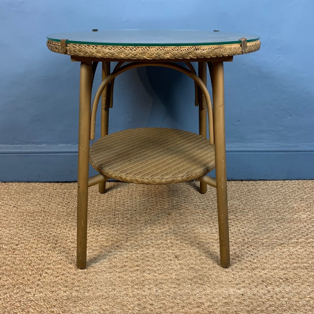 A 1930s Lloyd Loom 2 tier circular conservatory table with original glass top.