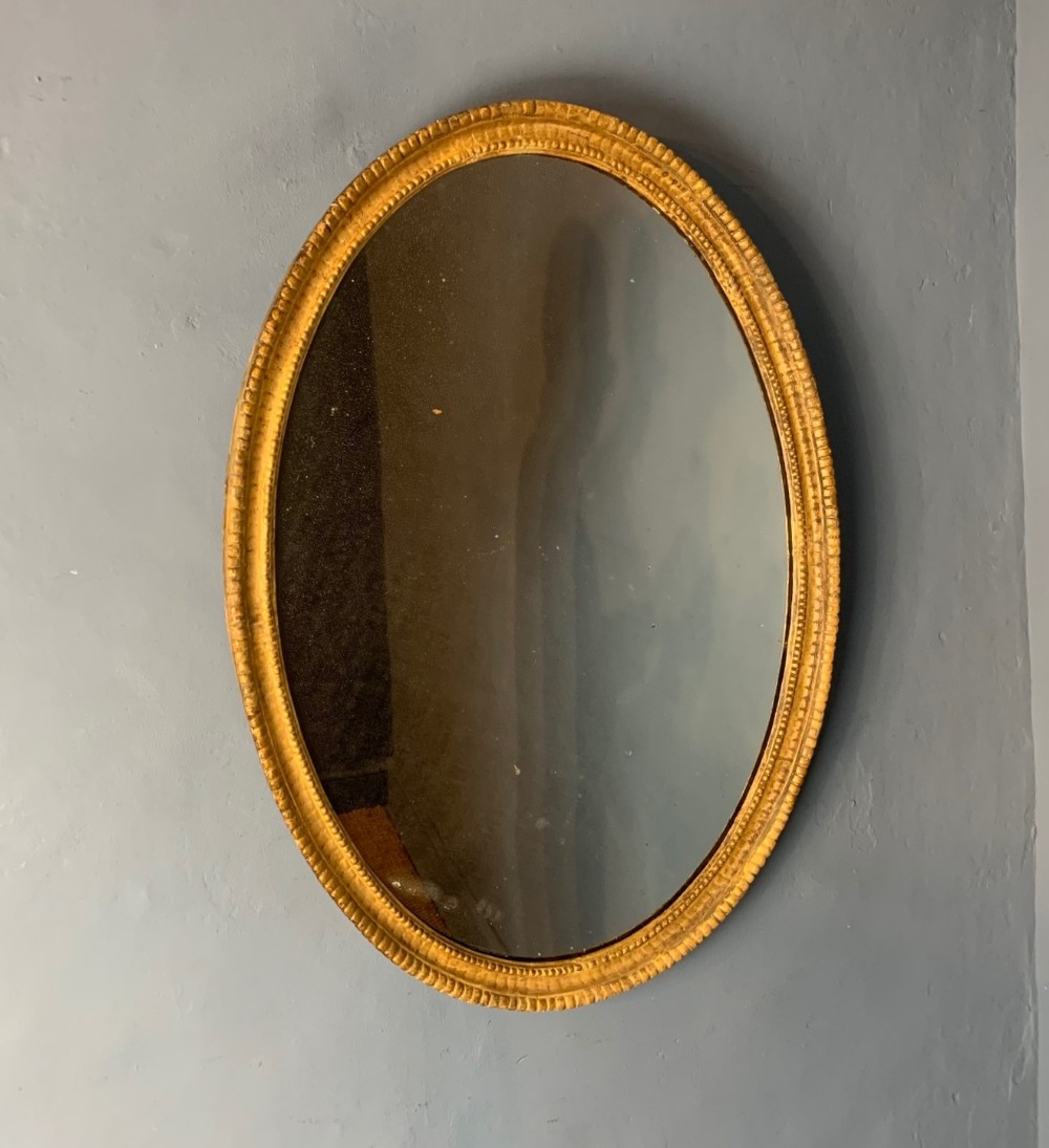 A George 111 carved gilt oval mirror circa 1790 