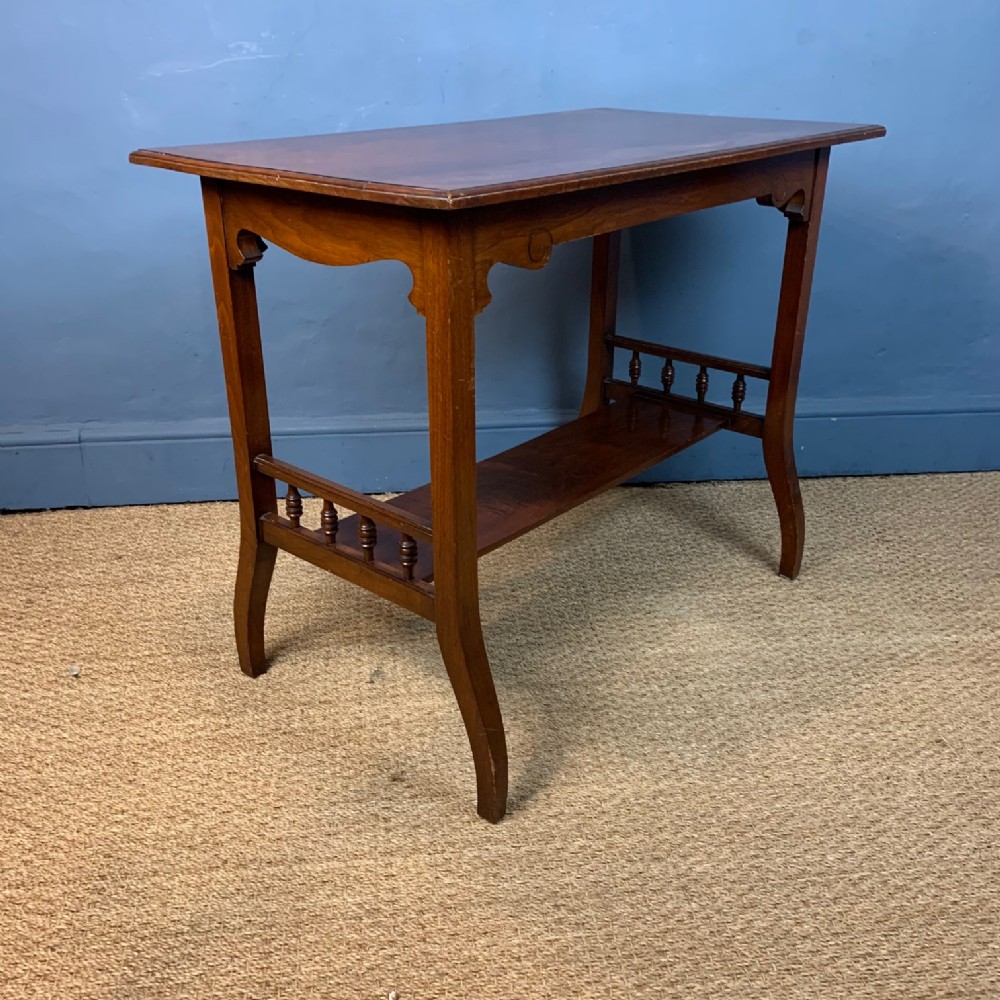 An Aesthetic Movement walnut 2 tier side table circa 1890 .