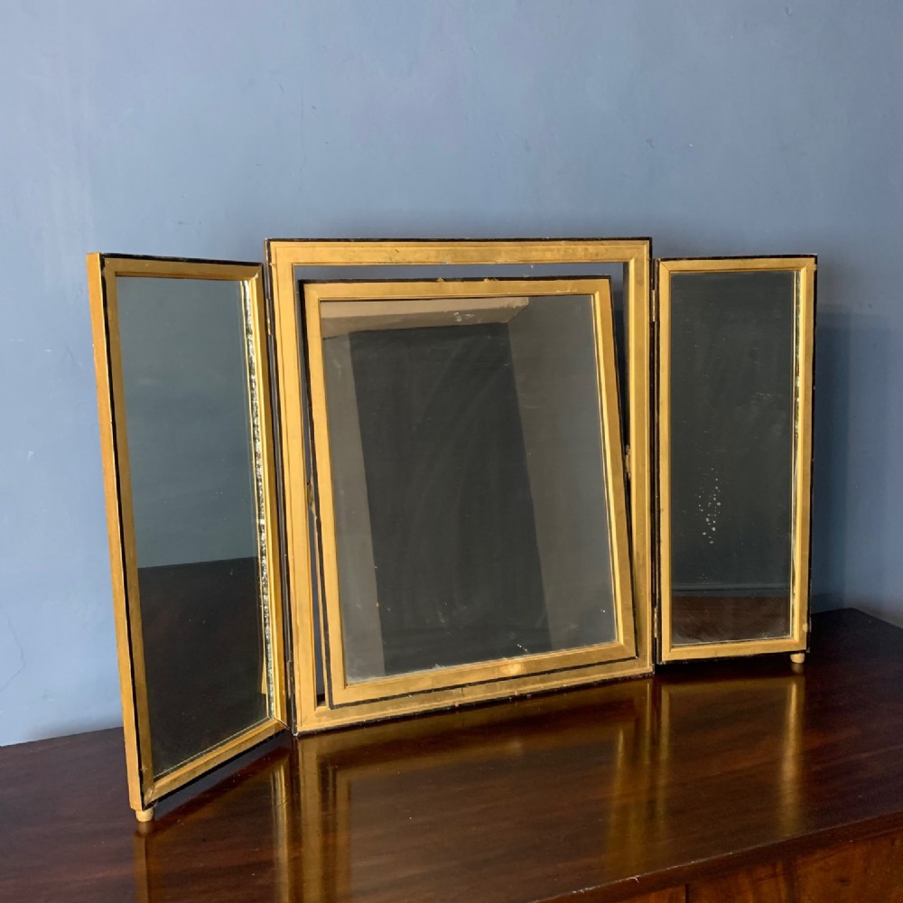 An Art Deco gilt and ebonised triptych dressing table mirror circa 1930.