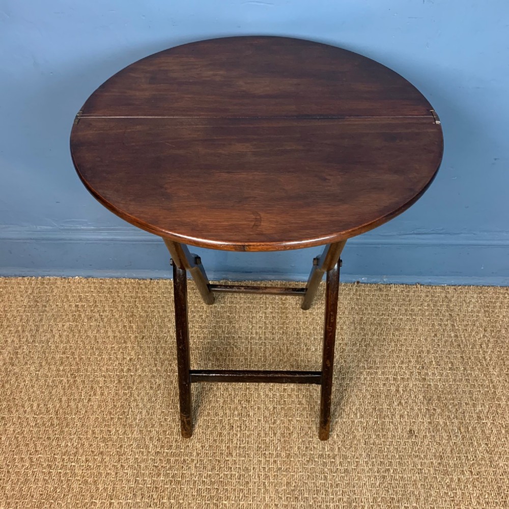 A small late Georgian circular folding coaching table circa 1830