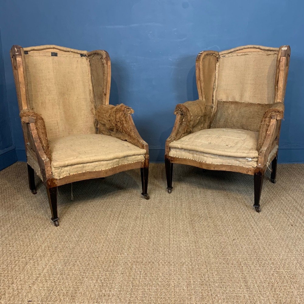 A pair of large Edwardian wing armchairs c 1910