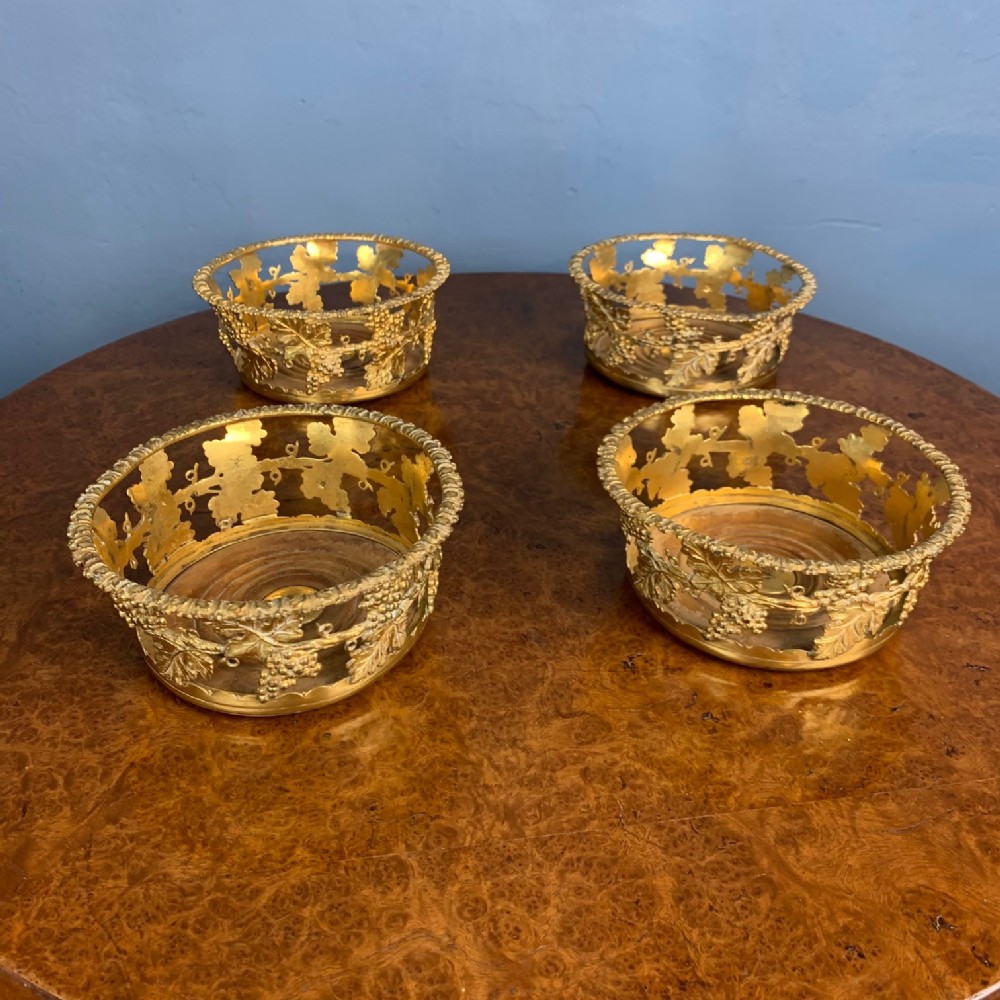 A rare set of four George 1V ormolu wine bottle holders circa 1830 