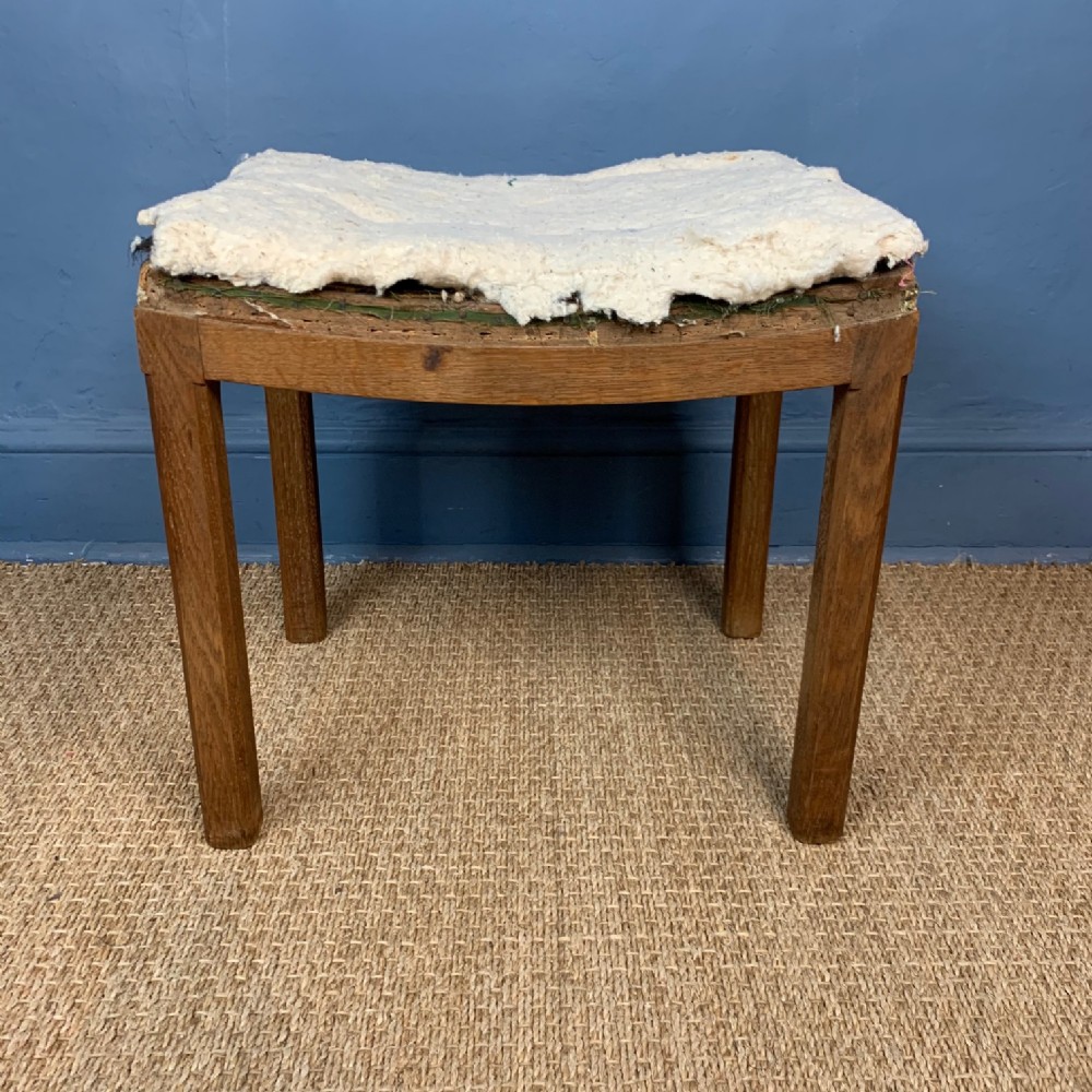 A Cotswold oak saddle seated stool circa 1930