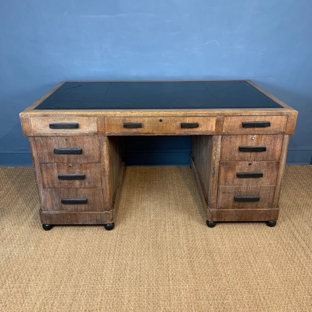 A large Art Deco oak and ebonised freestanding limed oak pedestal desk circa 1930