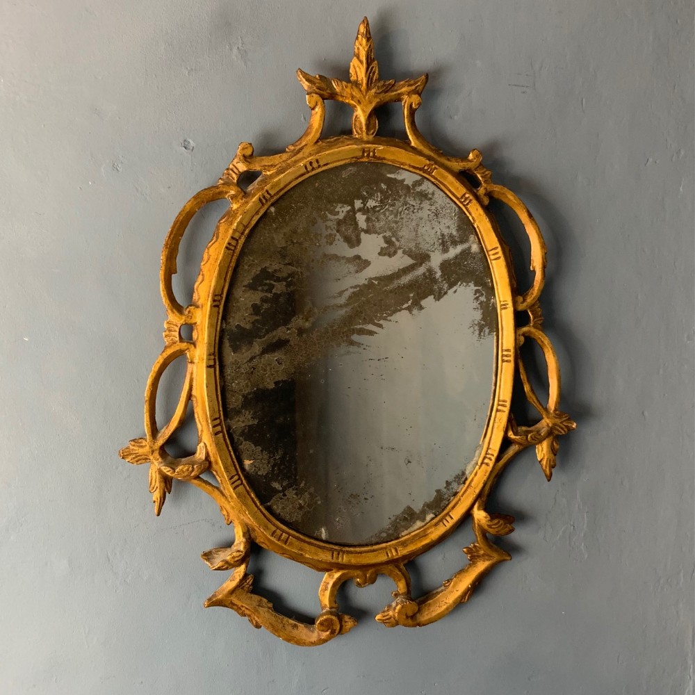 An early George 111 Chippendale period gilt oval mirror circa 1760
