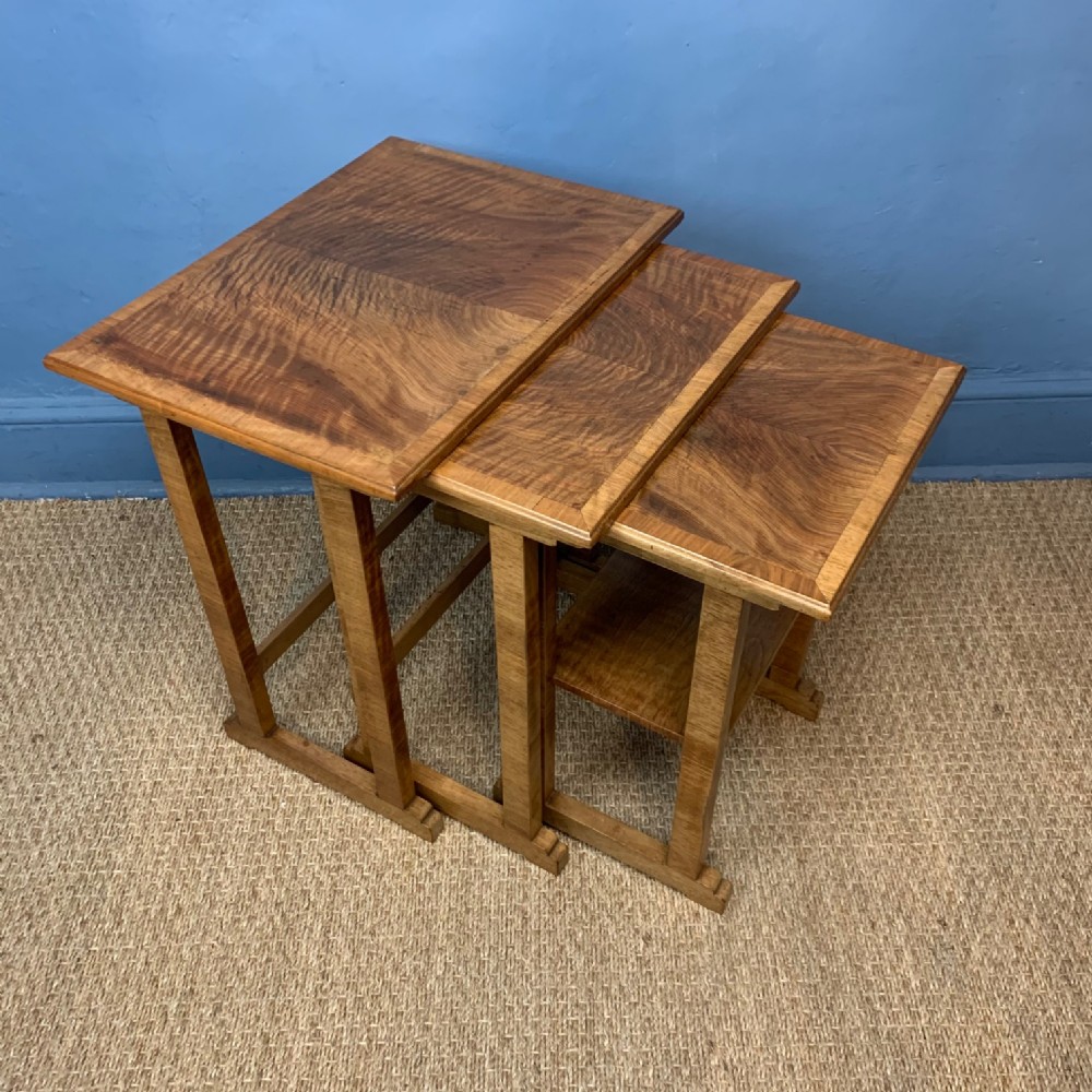 A nest of three Heals walnut tables circa 1930