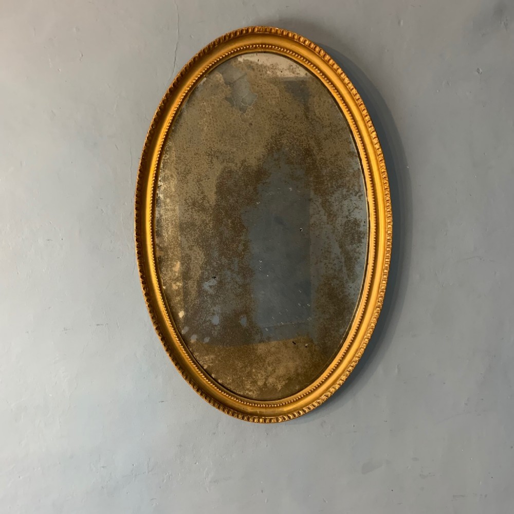 A George 111 gilt oval mirror circa 1790