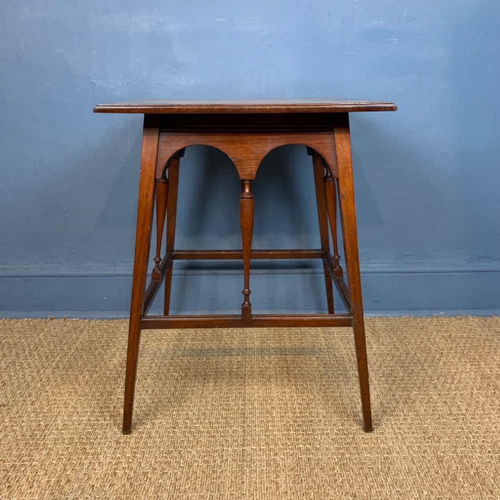 An Aesthetic Movement walnut table in the style of Morris and Co