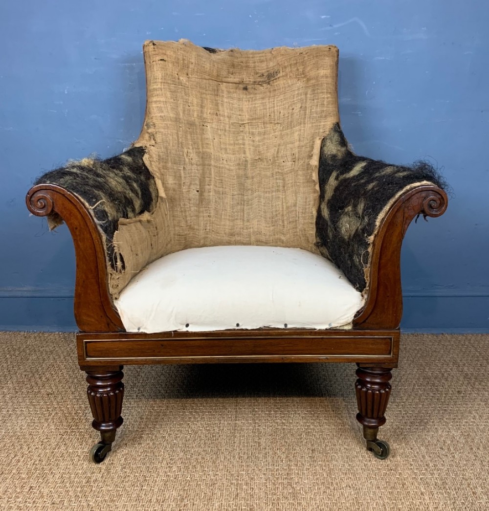 A large George IV mahogany and brass mounted library bergere chair circa 1825