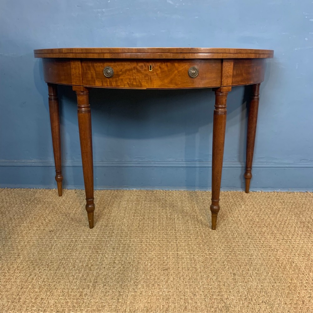 A George 111 mahogany half round table circa 1800
