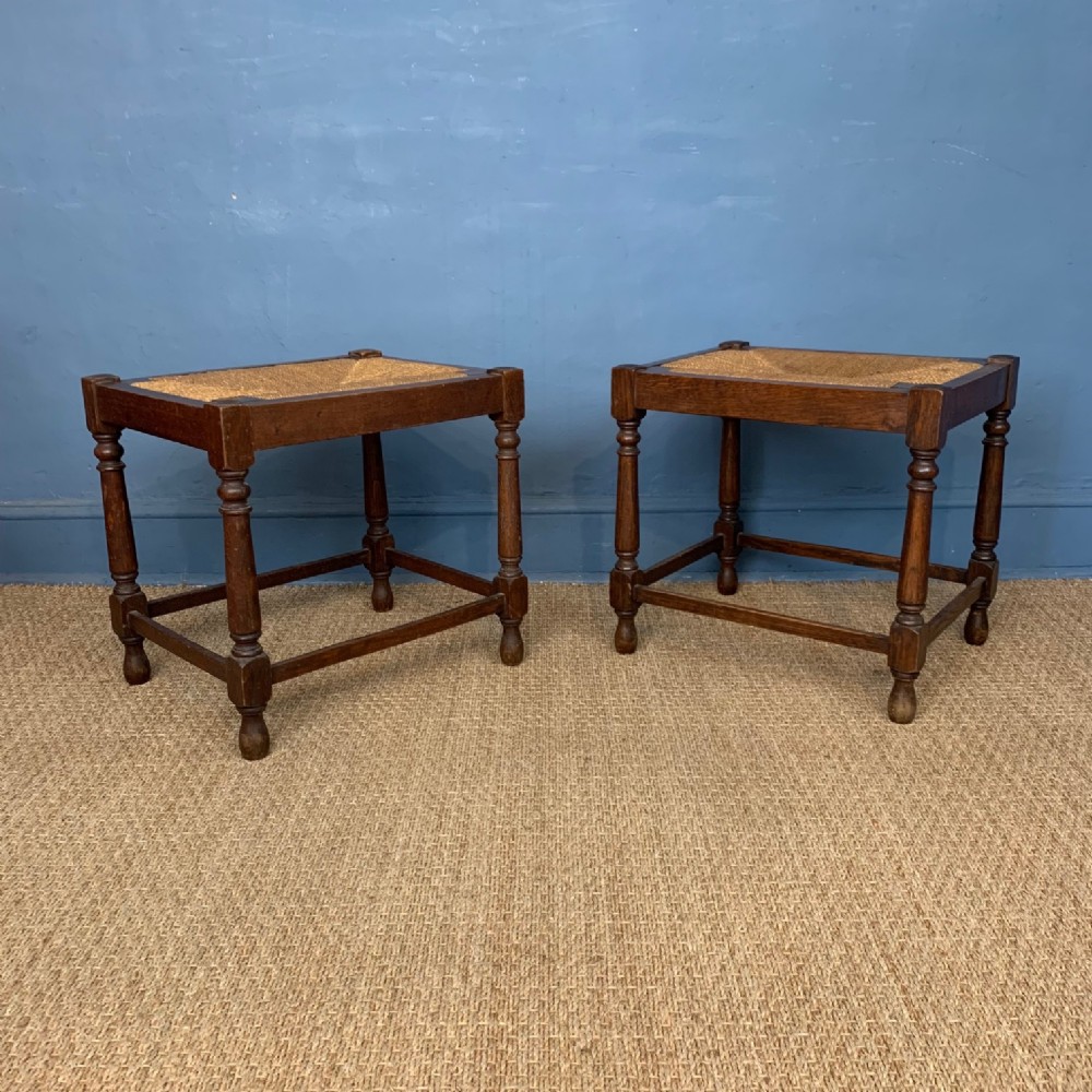 A pair of Cotswolds School oak stools circa 1920 
