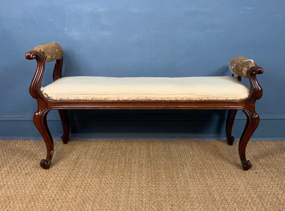An early Victorian mahogany scrolled armed window seat circa 1850