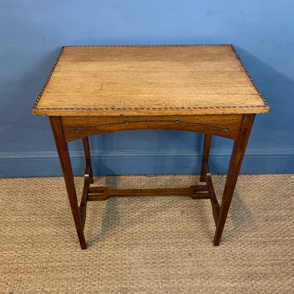 A Scottish Arts and Crafts oak table attributed to Wylie and Lochhead circa 1905