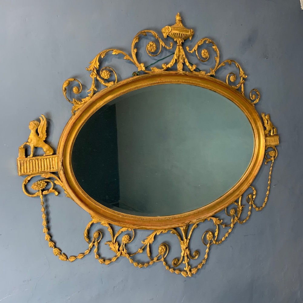 A large Victorian oval giltwood mirror circa 1880 