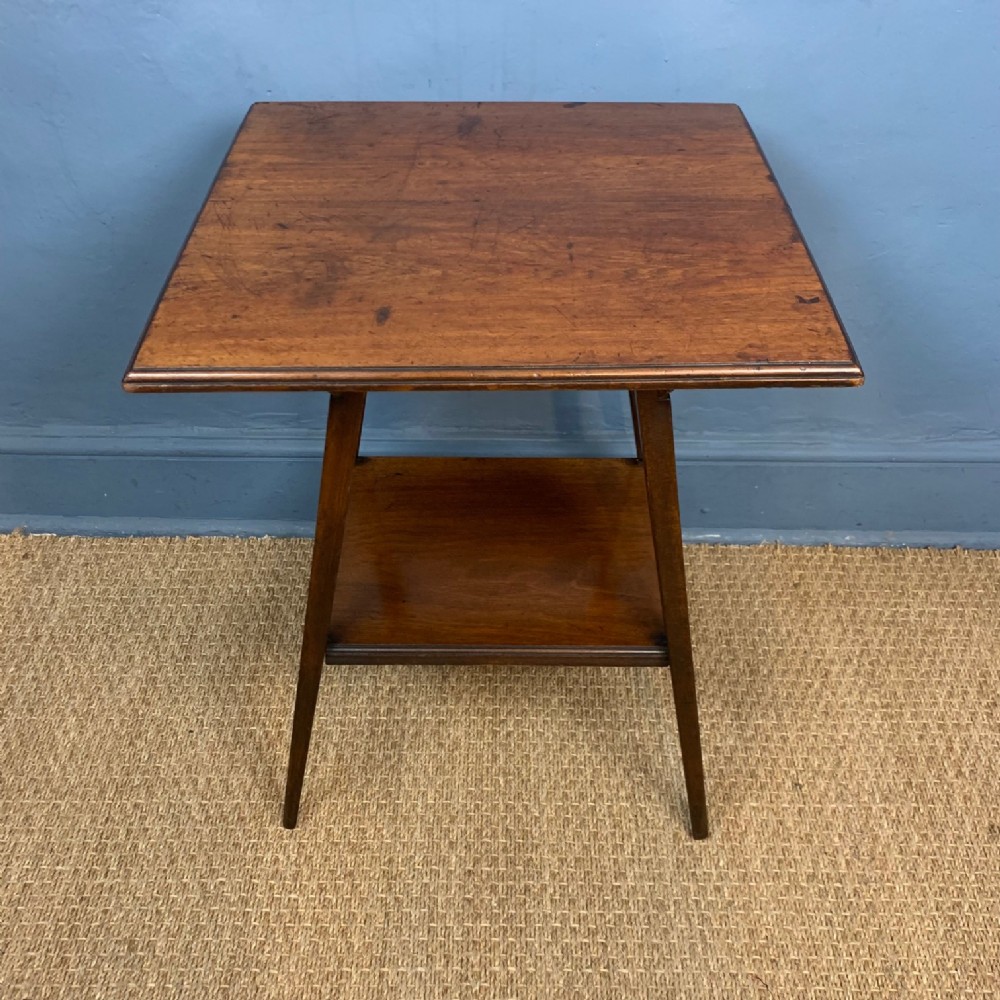 An Aesthetic Movement walnut 2 tier table circa 1890 .