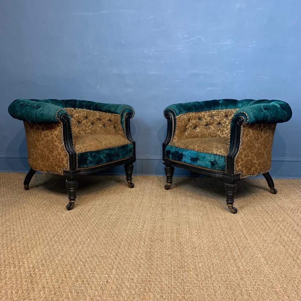 A pair of Irish Aesthetic Movement ebonised tub chairs circa 1890
