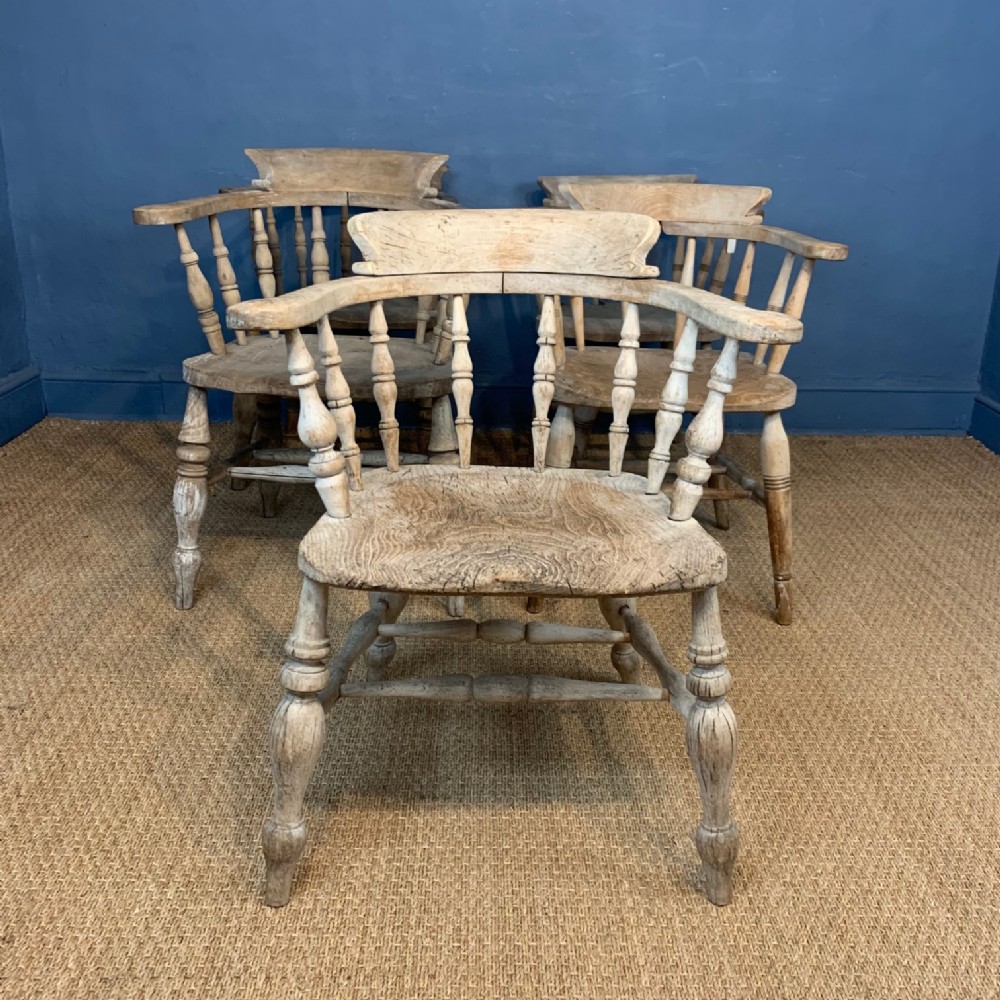 A matched set of five late 19th century elm and beech smokers bow Windsor chairs Circa 1900
