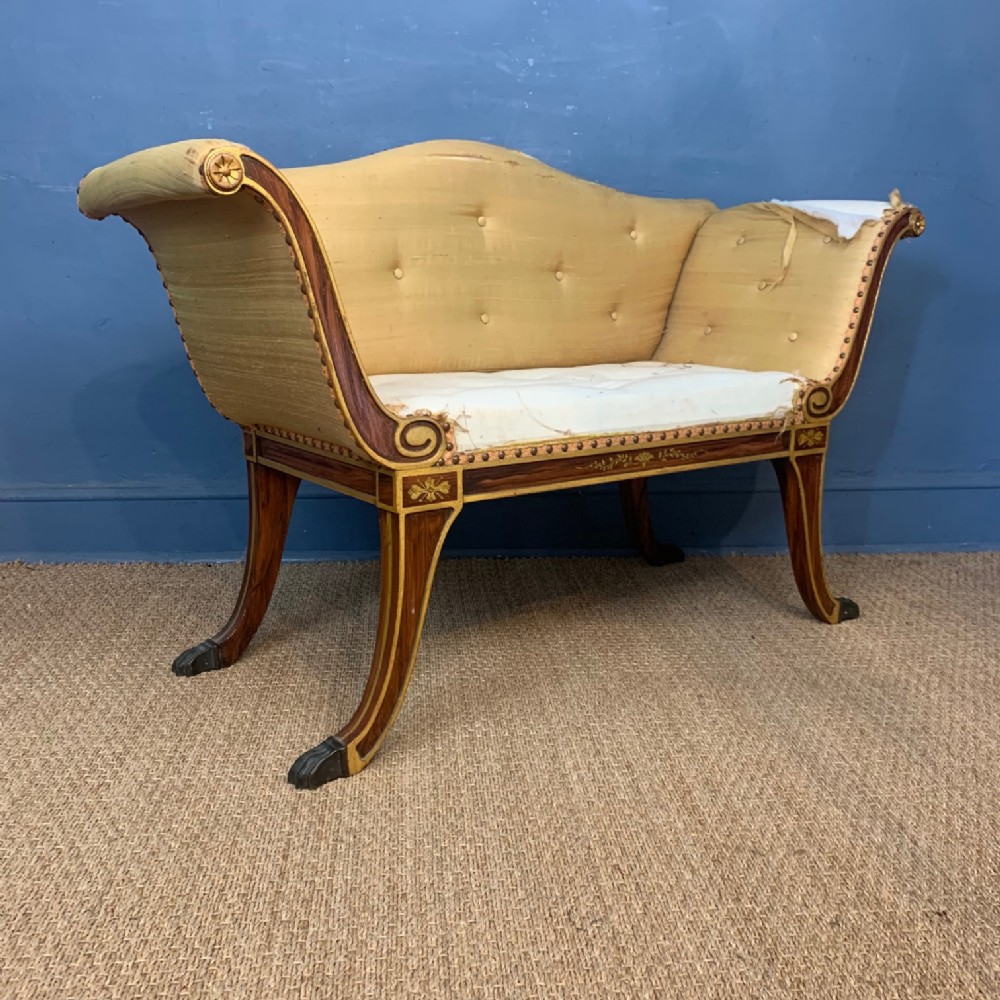 A Regency style faux rosewood and parcel gilt window seat circa 1910
