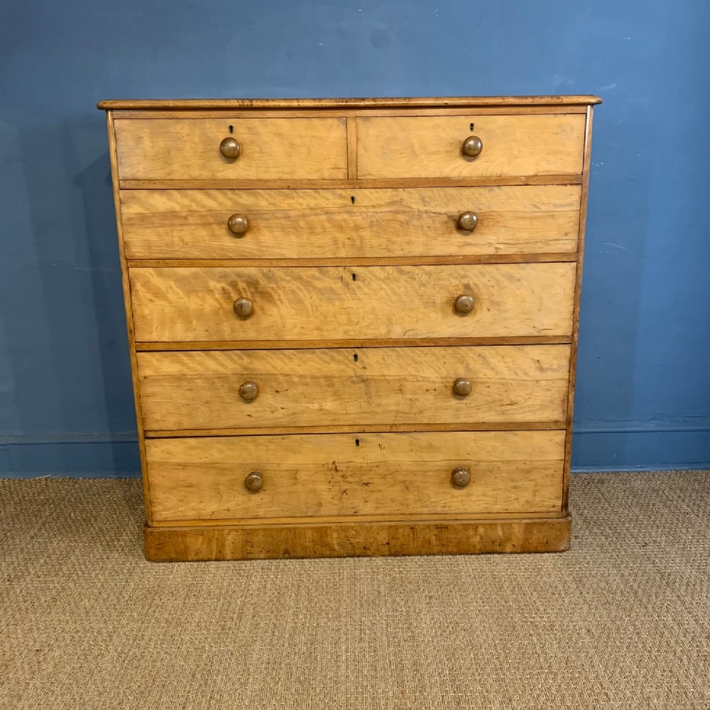A large and early Heals satinbirch chest of drawers circa 1870