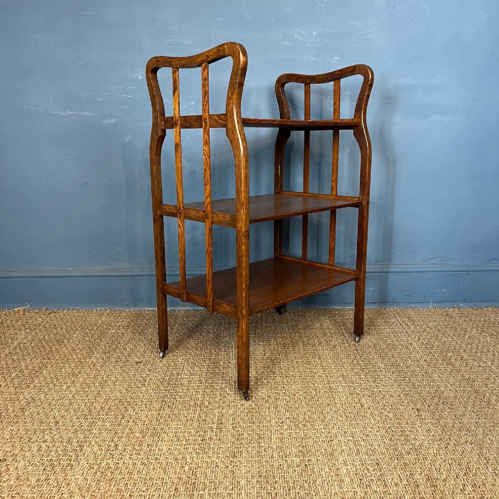 An unusual Arts and Crafts oak 3 tier table probably Scottish circa 1910 .