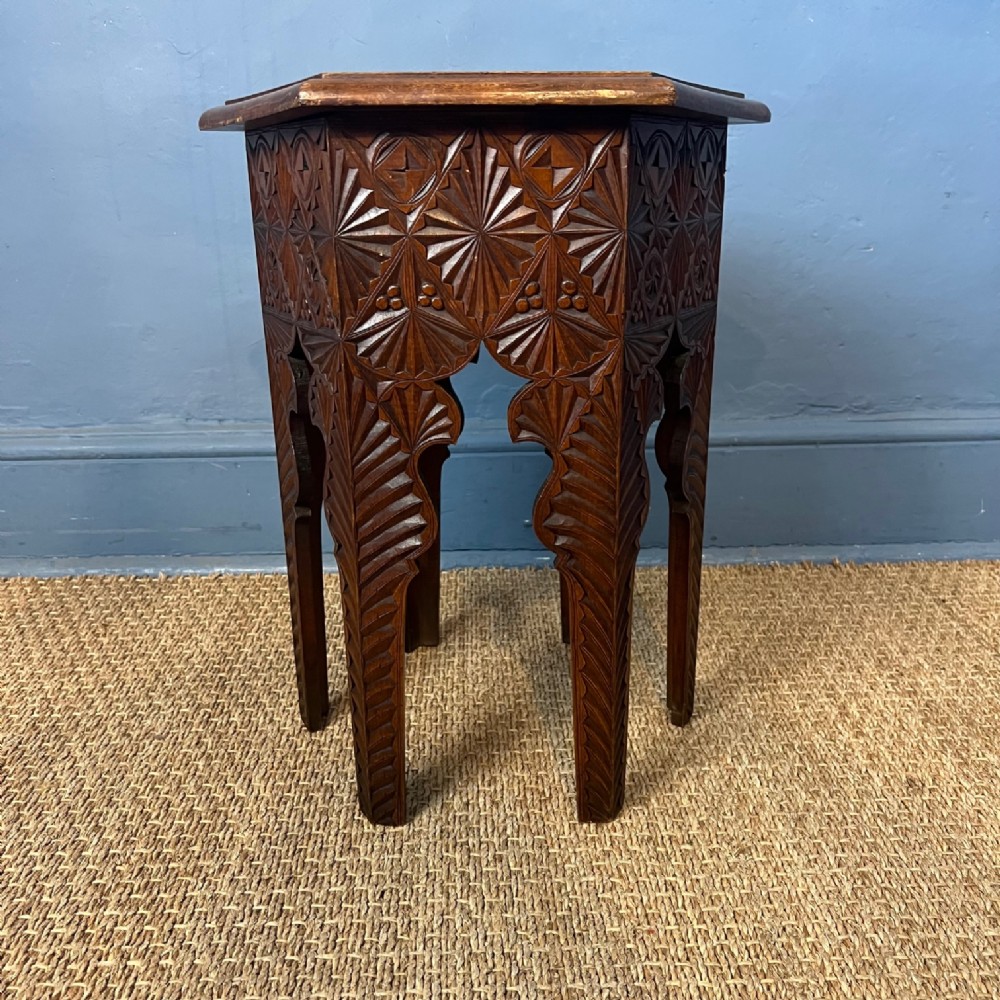 An Arts and Crafts chip carved walnut hexagonal table circa 1910