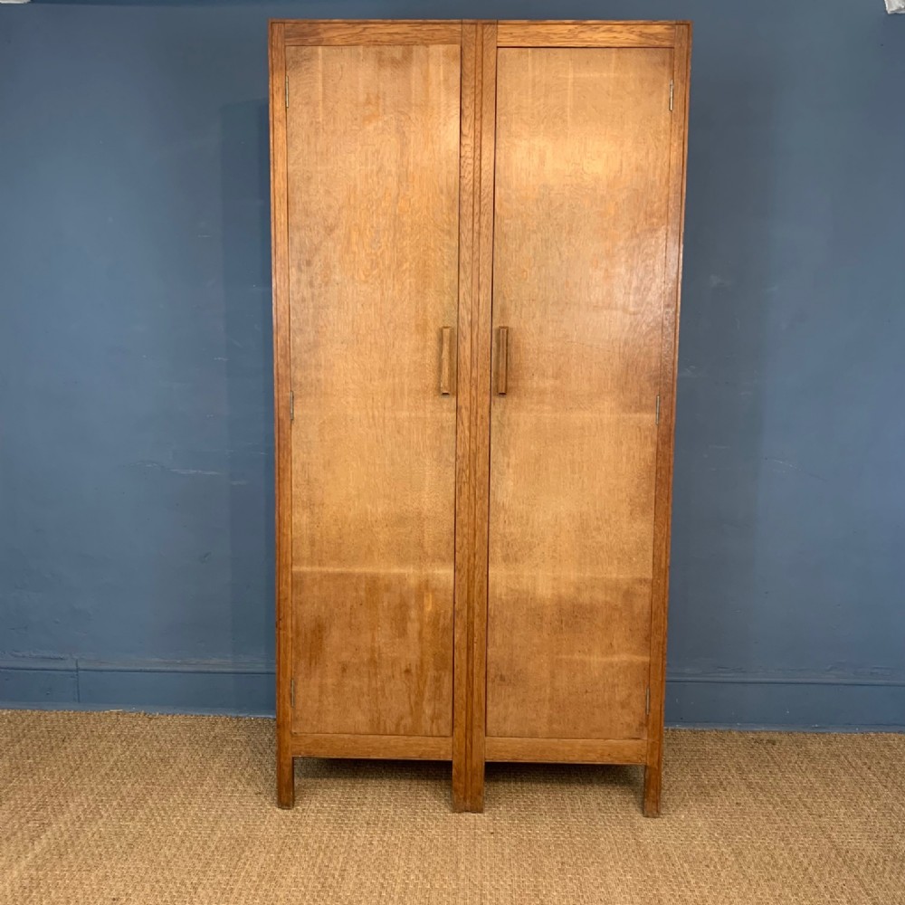 A Heals limed oak 2 door wardrobe circa 1930