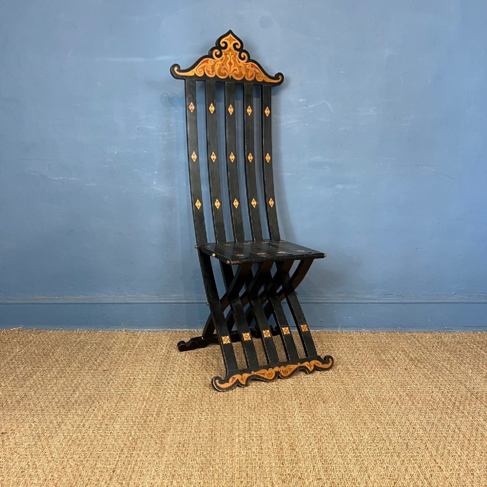 An unusual Arts and Crafts ebonised and inlaid Savonarola type slatted chair circa 1910