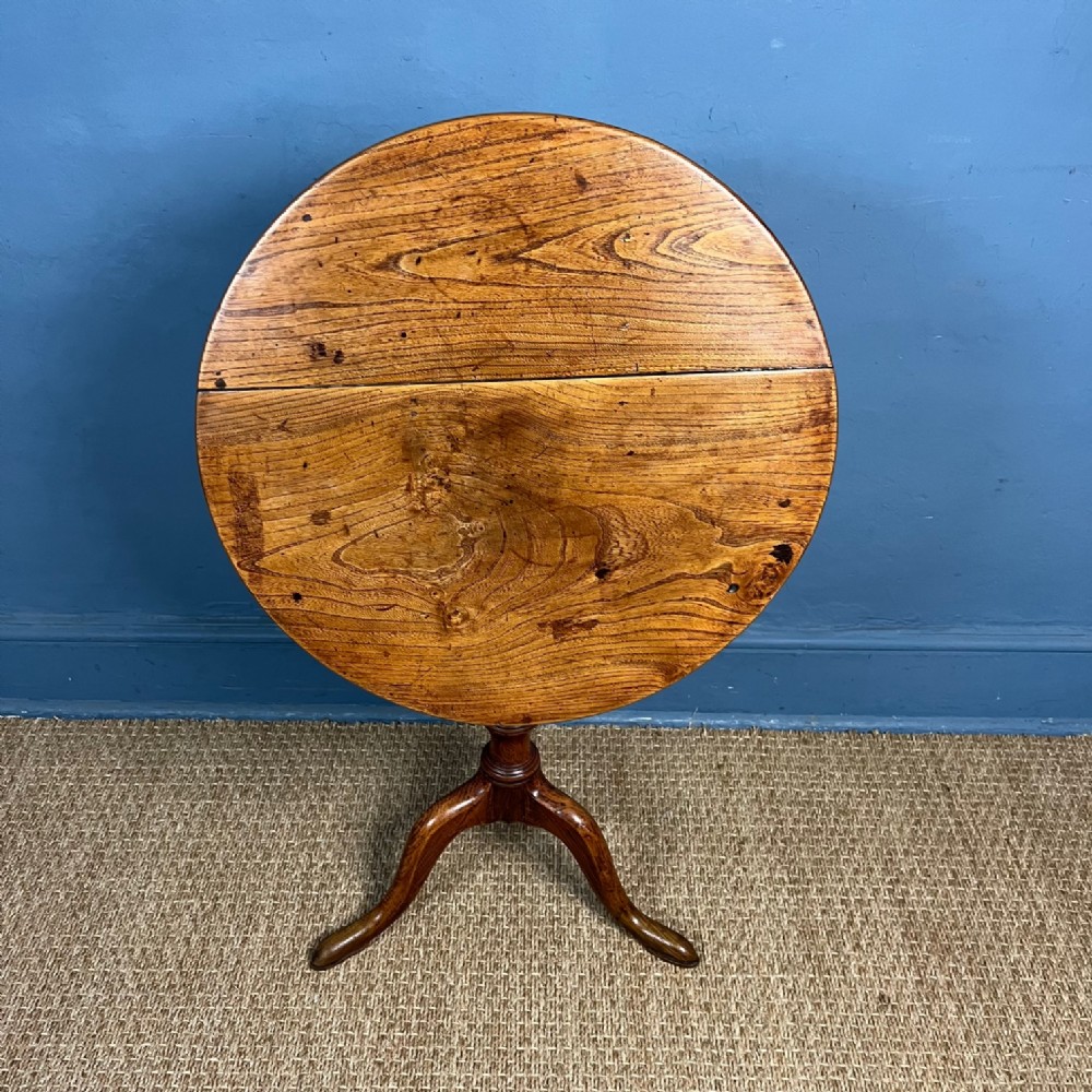 A Georgian elm tripod table circa 1820