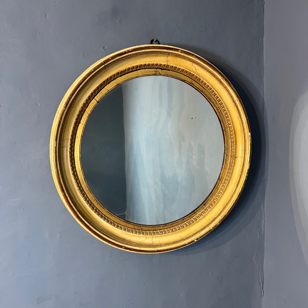 A large mid 19th painted and gilt circular mirror circa 1840