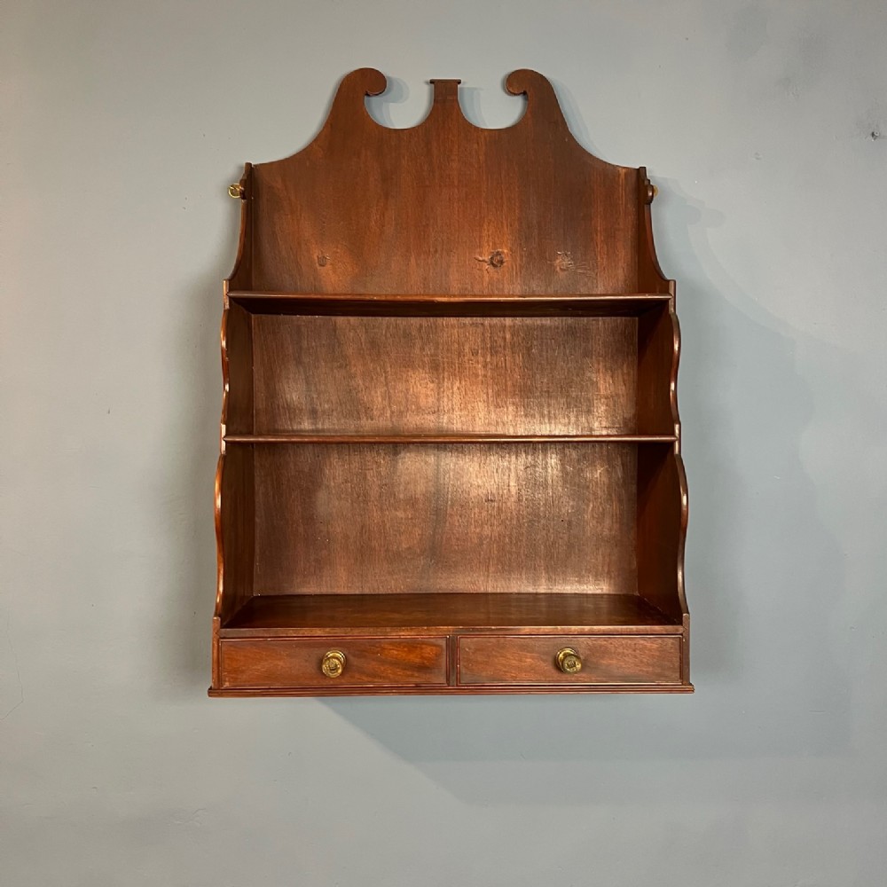 A George 111 mahogany set of hanging shelves circa 1800