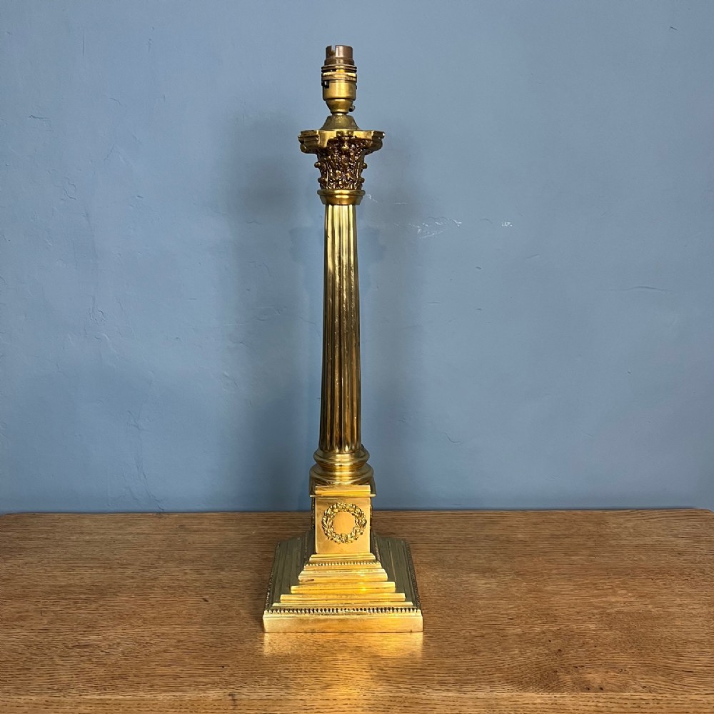 An Edwardian brass Corinthian column table lamp circa 1910 .