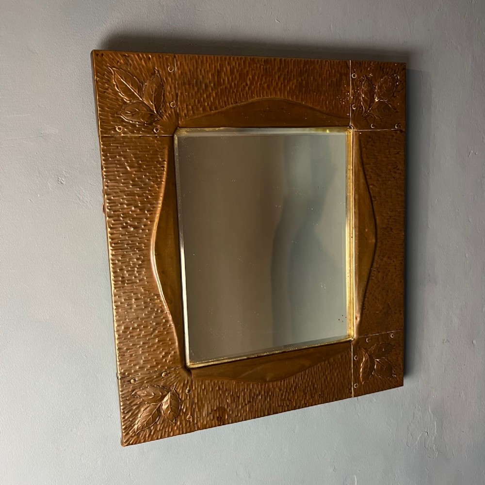 A Newlyn pressed copper wall mirror circa 1910
