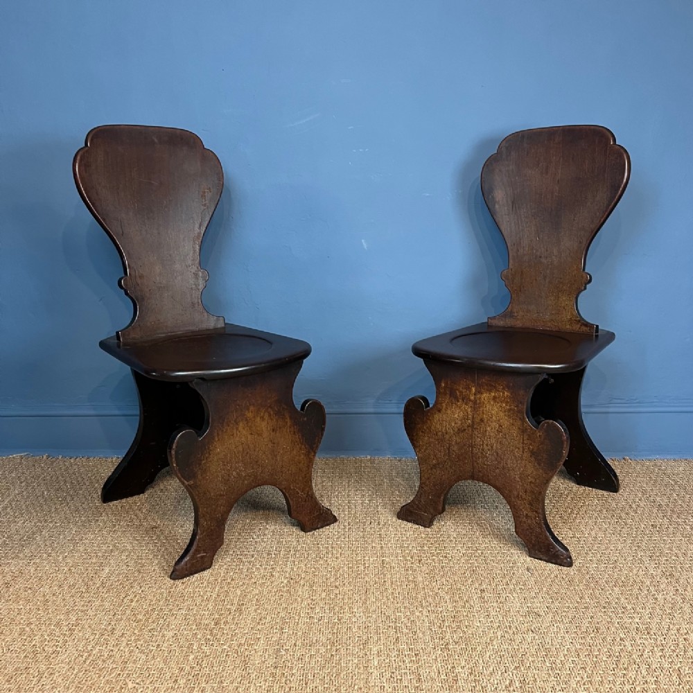 A pair of early George III mahogany Sgabello Hall chairs circa 1760