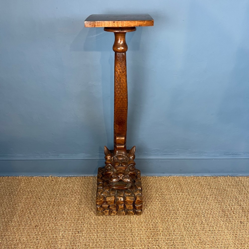 A late 19th century carved walnut pedestal in the form of a 