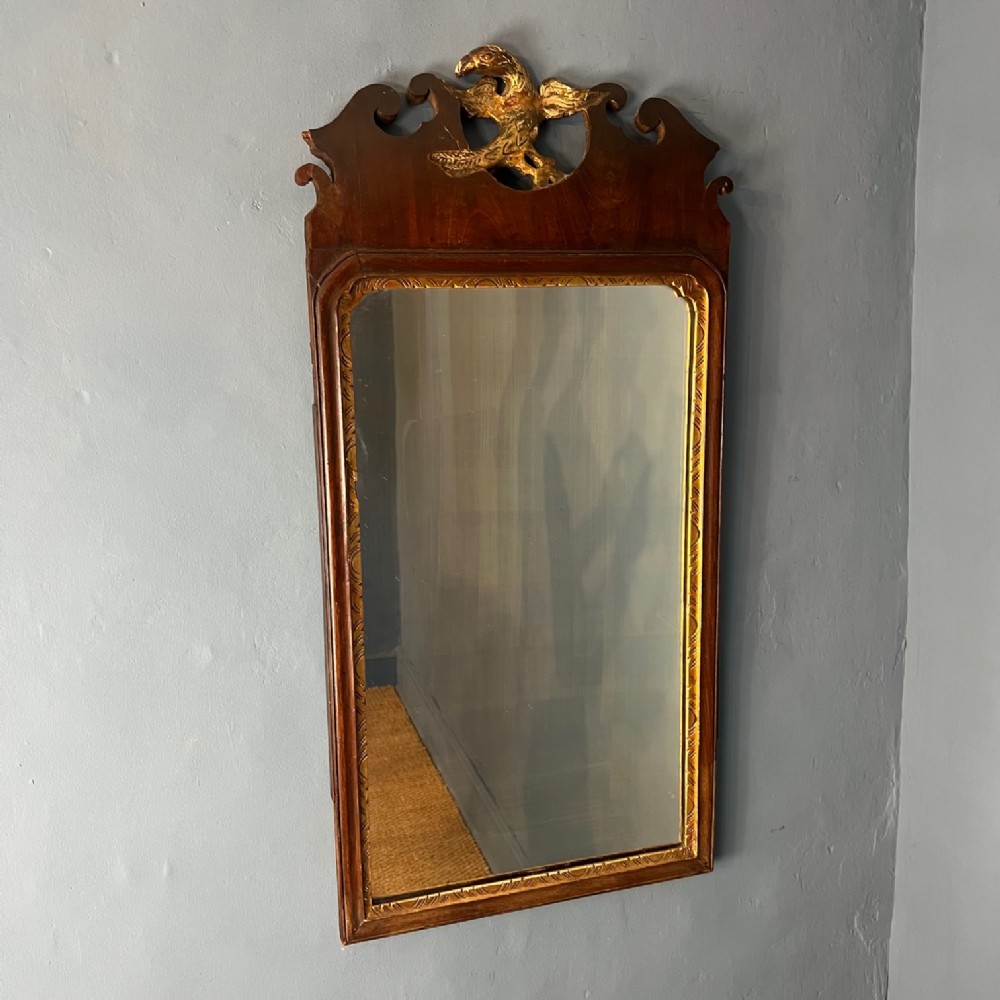An 18th c walnut and parcel gilt wall mirror