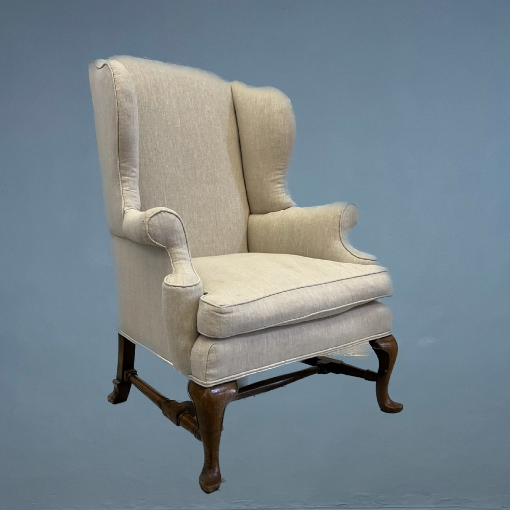 An Edwardian walnut wing chair circa 1910 in George I style 