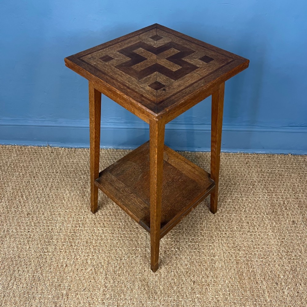 An Arts and Crafts oak and parquetry table circa 1910
