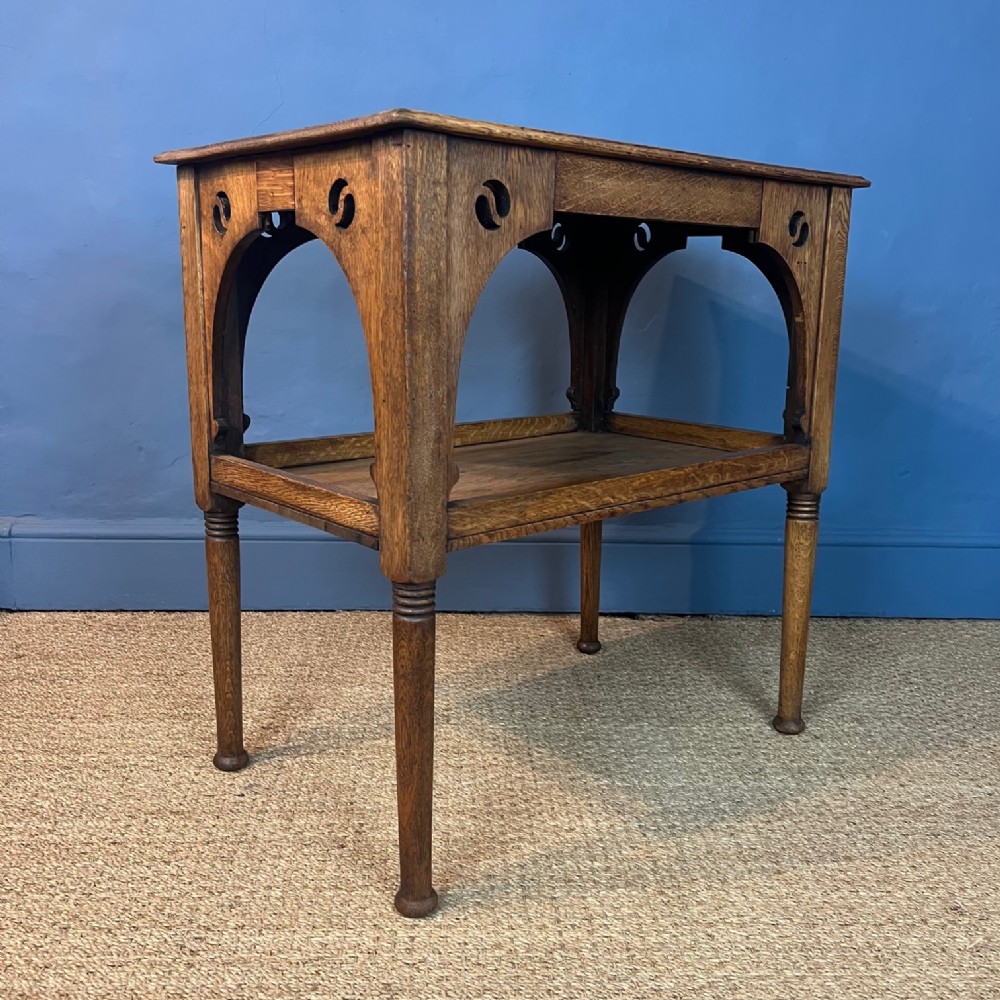 A Liberty and Co oak rectangular 2 tier table circa 1890 in Moorish Style .