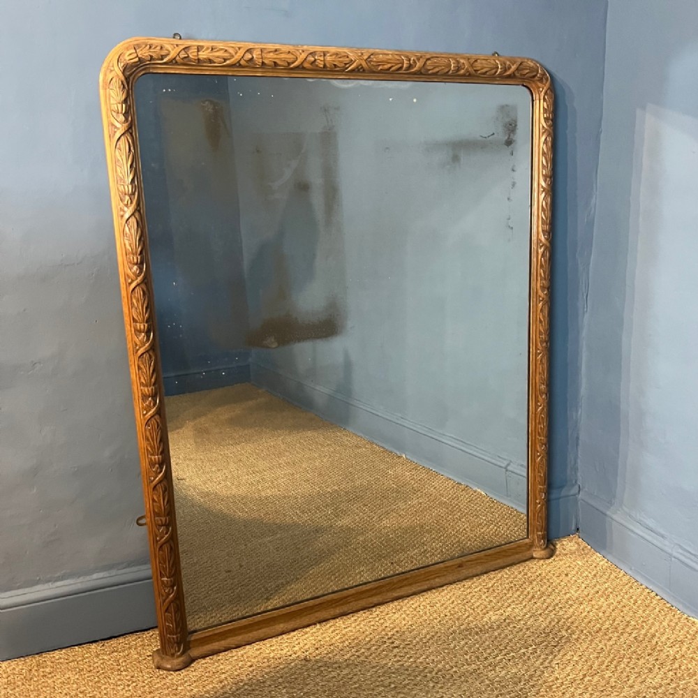 A Victorian carved oak overmantel mirror circa 1850 